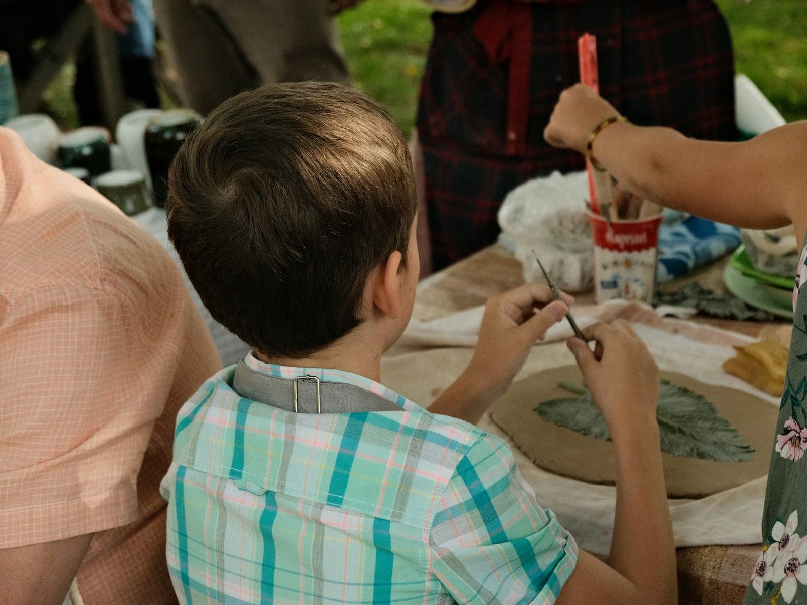 Children work with clay at a craft table