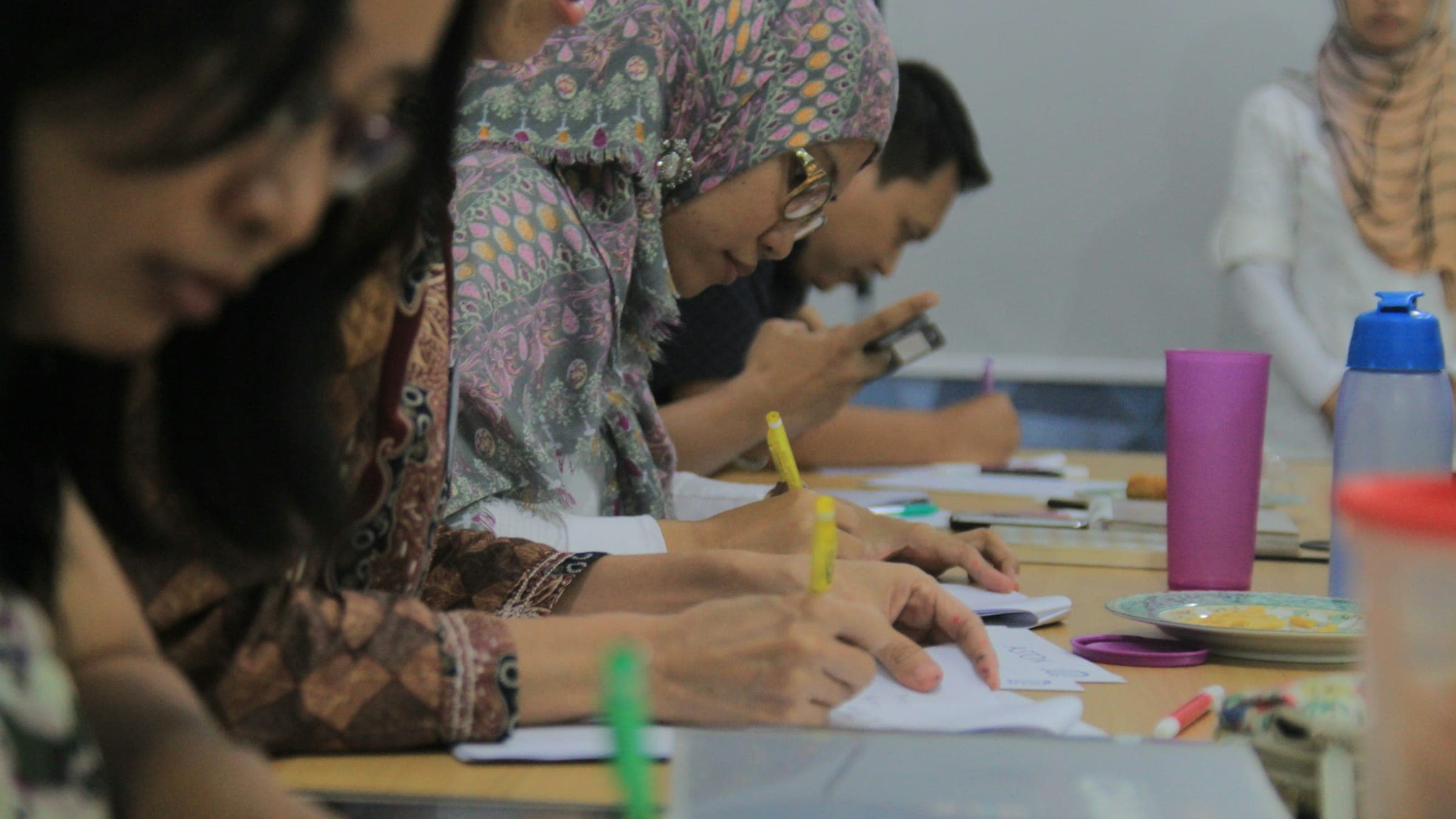 Participants take notes during a professional training workshop
