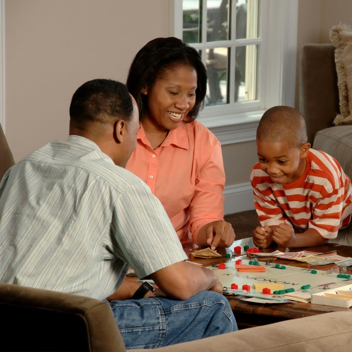 A family plays a board game together at home