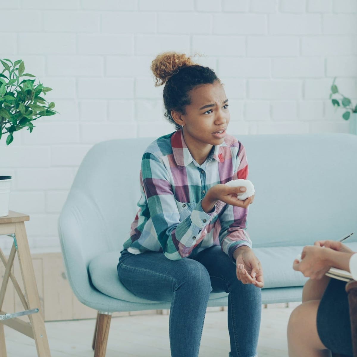 A teenager talks with a support professional